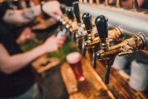 Barman,Hands,Pouring,A,Lager,Beer,In,A,Glass.